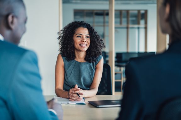 Shot of group of business persons in business meeting. Three entrepreneurs on meeting in board room. Corporate business team on meeting in modern office. Female manager discussing new project with her colleagues. Company owner on a meeting with two of her employees in her office.